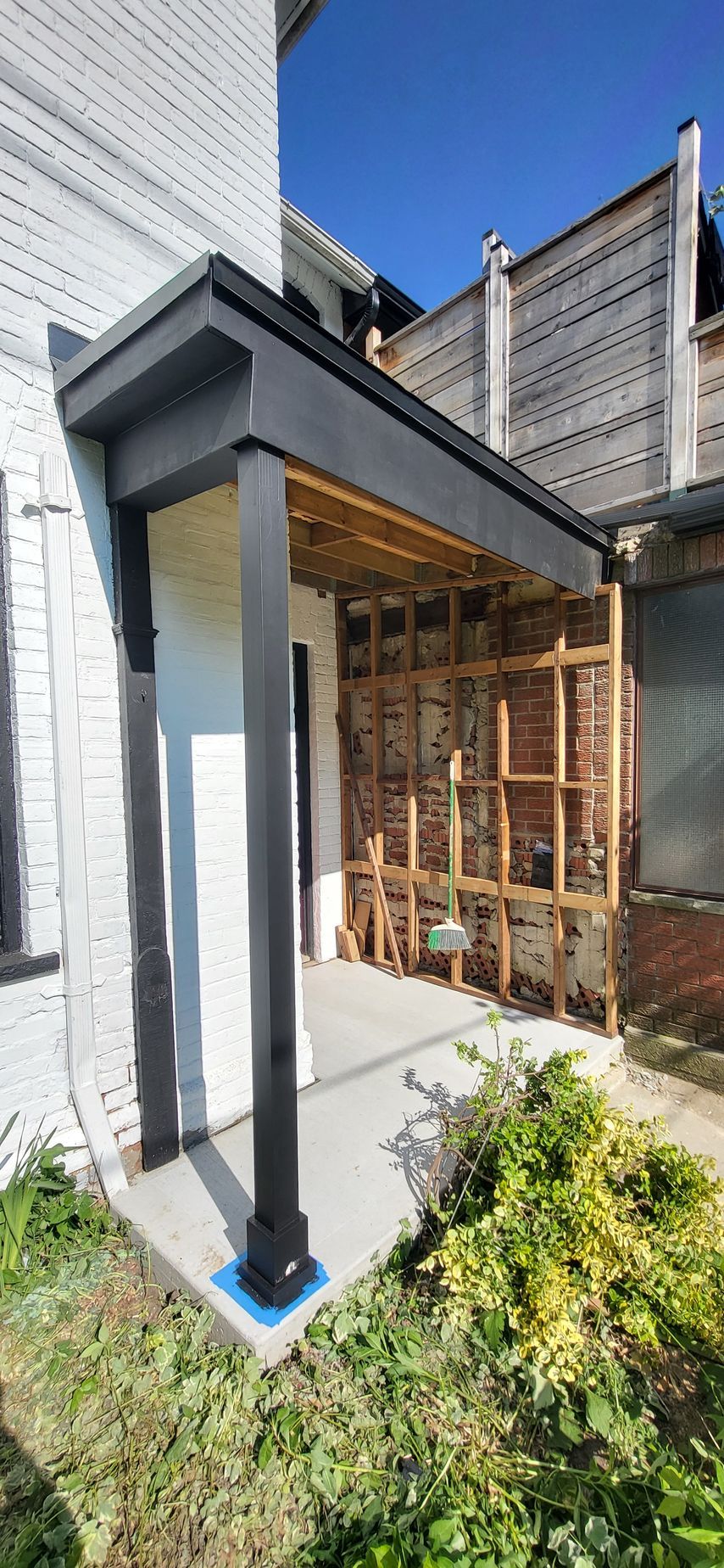 A porch is being built on the side of a house.