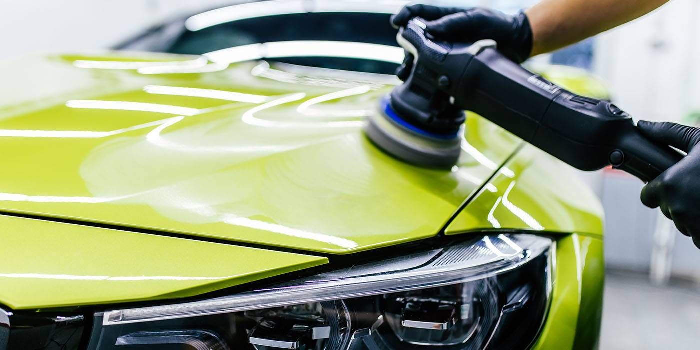 A close up of a high pressure washer spraying water on a concrete surface.