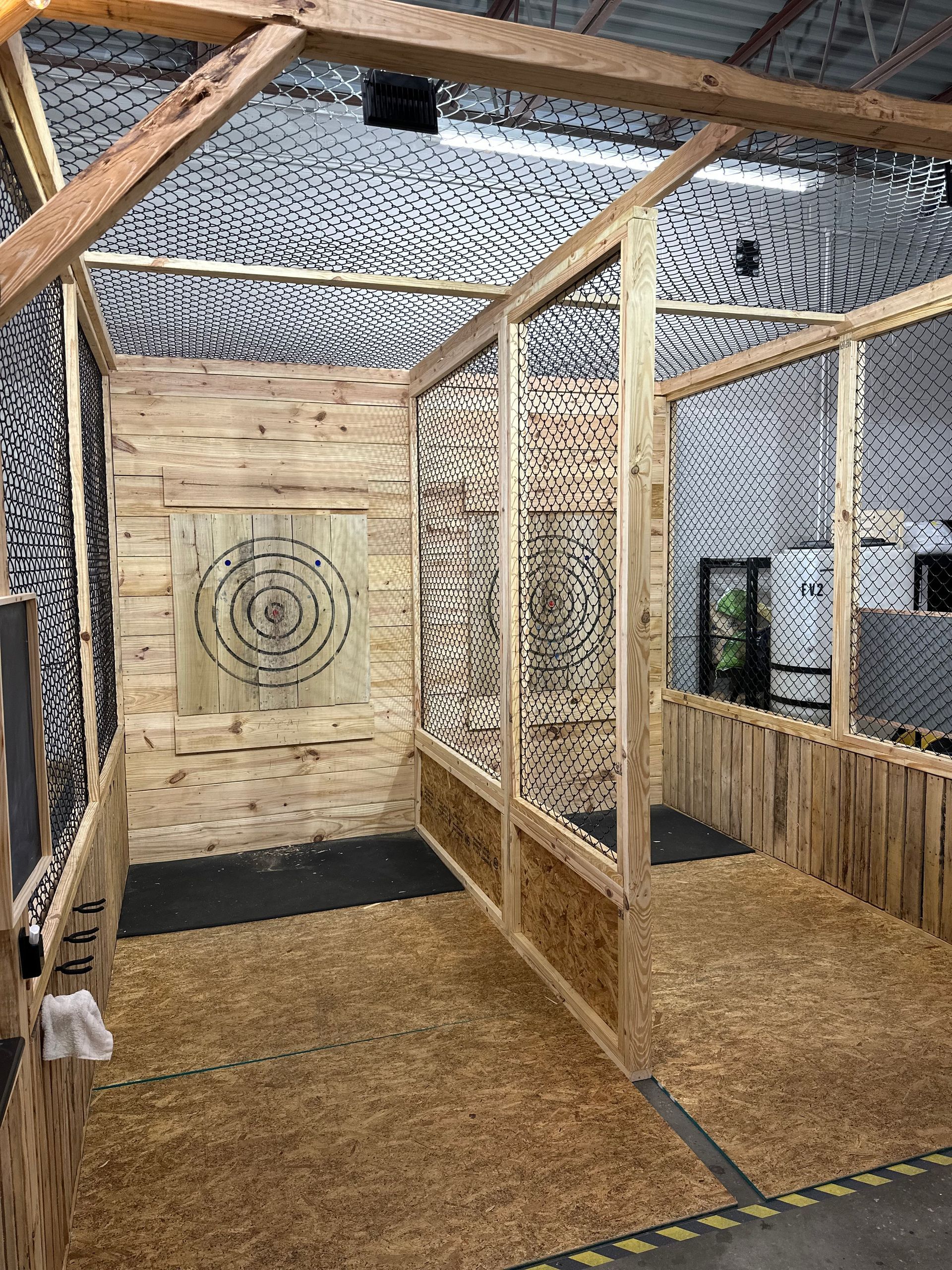 A room with wooden walls and a target on the wall.