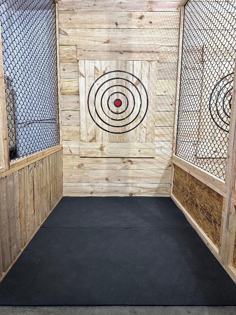 There is a target on the wall in the middle of the room.