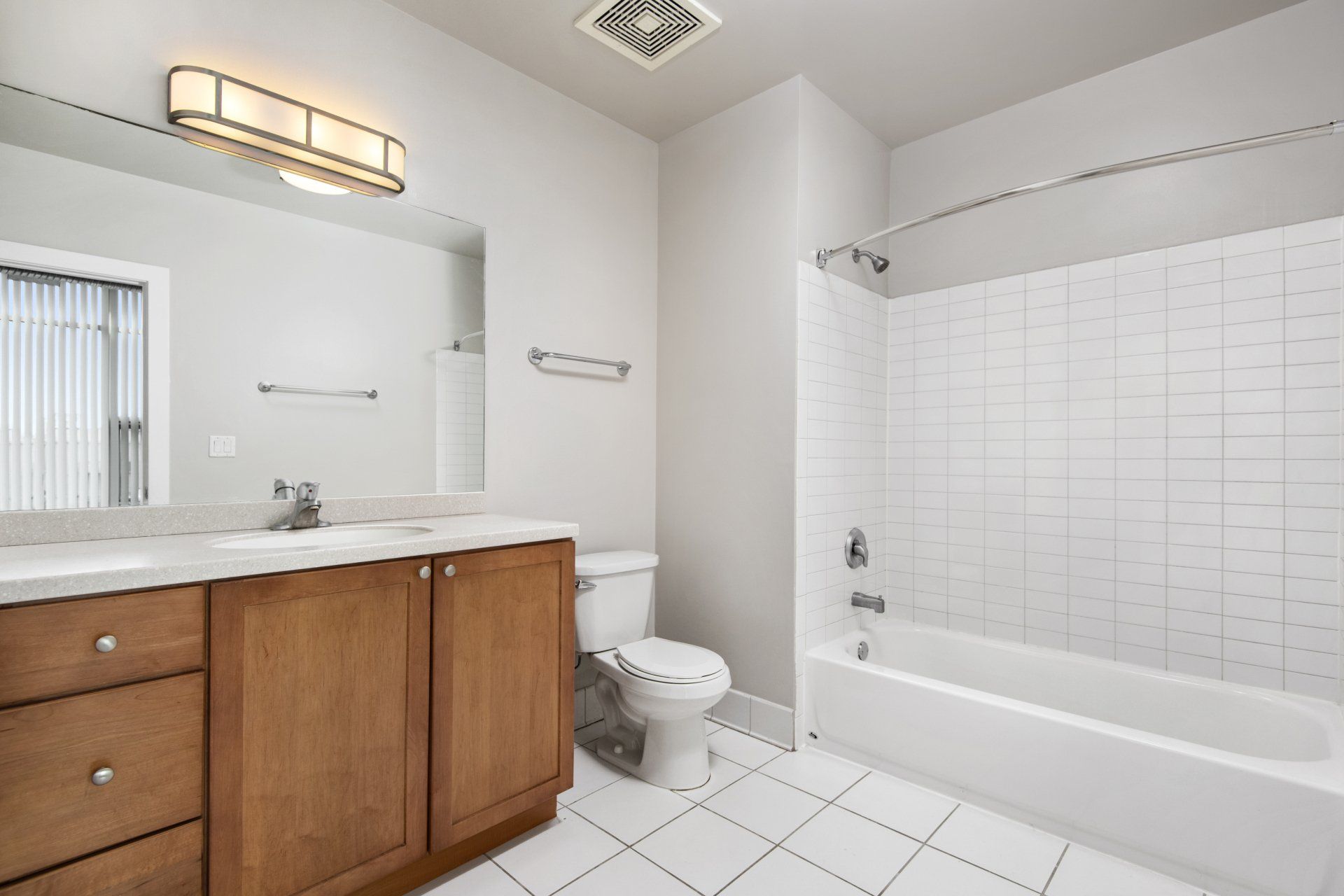 A bathroom with a toilet , sink , and bathtub at 2000 N Milwaukee Apartments.