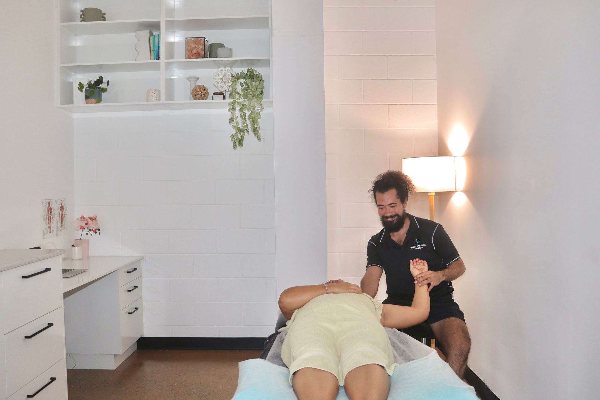 Physiotherapist A Beard Is Giving Another Man A Leg Massage — Inner Balance Health in Darwin