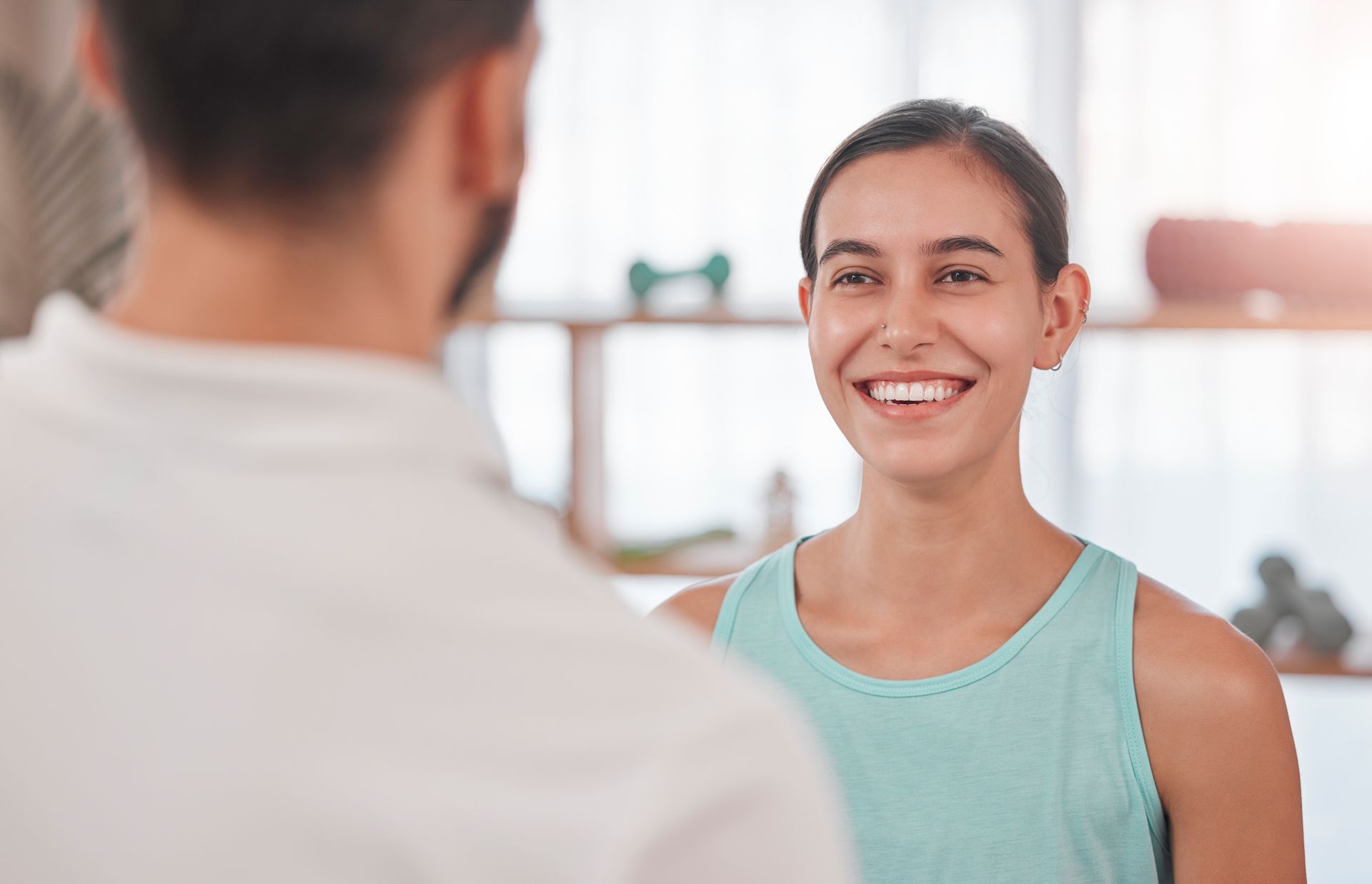 woman smiling at her physiotherapist — Inner Balance Health in Darwin