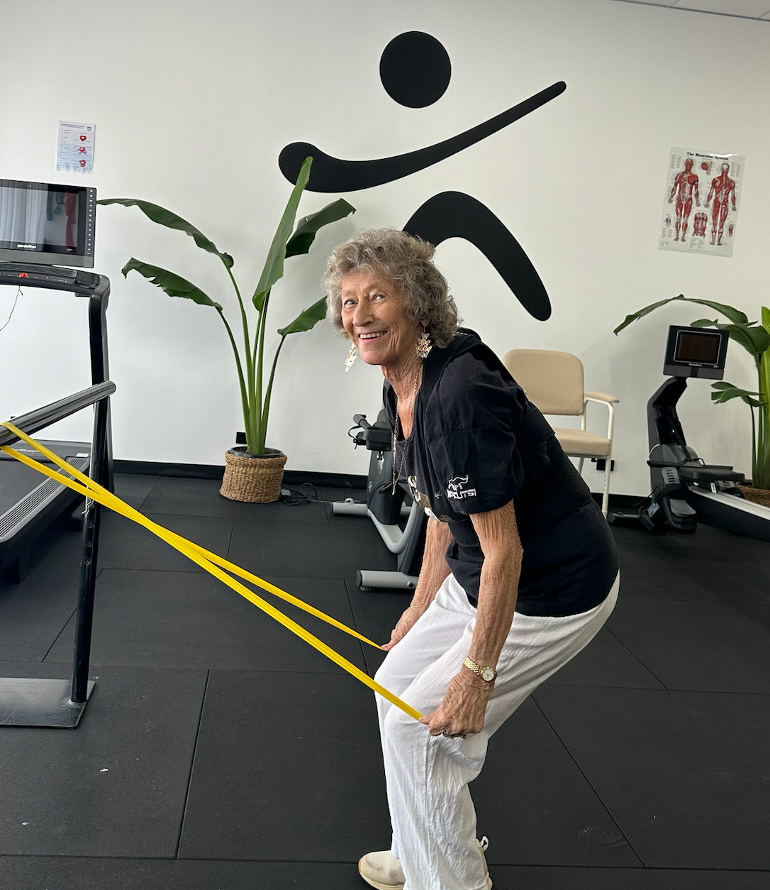 elderly woman using resistance bands — Inner Balance Health in Darwin