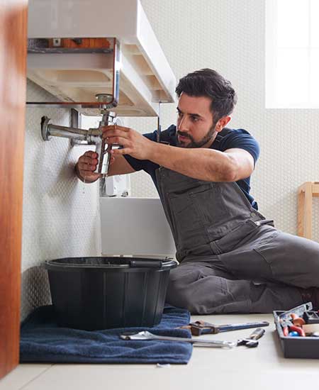 Plumber Fixing The Pipe