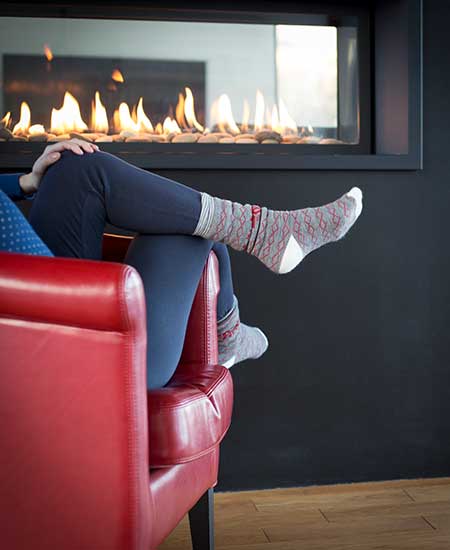 Sitting In Front Of Fireplace — Vestal, NY — Baker’s Plumbing Heating & Air