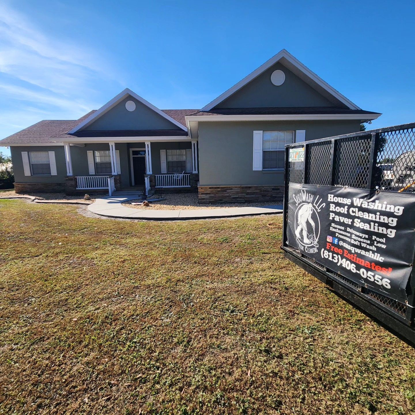 A large house with a sign in front of it.