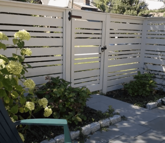 white metal fence enclosing a whittier homeowners patio and a secure gate door