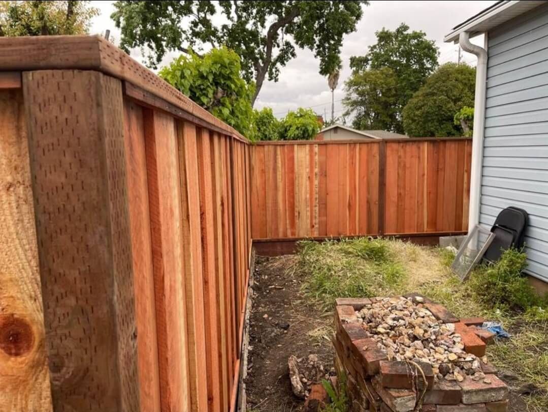 redwood fence going around a bend in unfinished backyard treated redwood fence posts