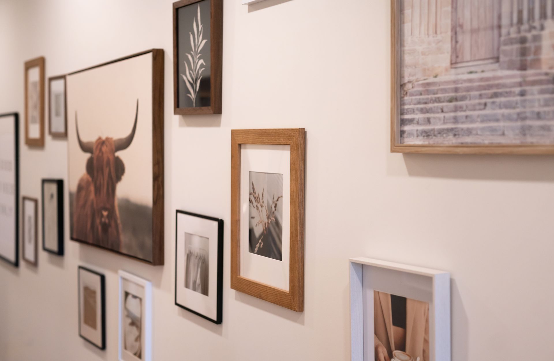 a woman is smiling and touching her face with her hands .