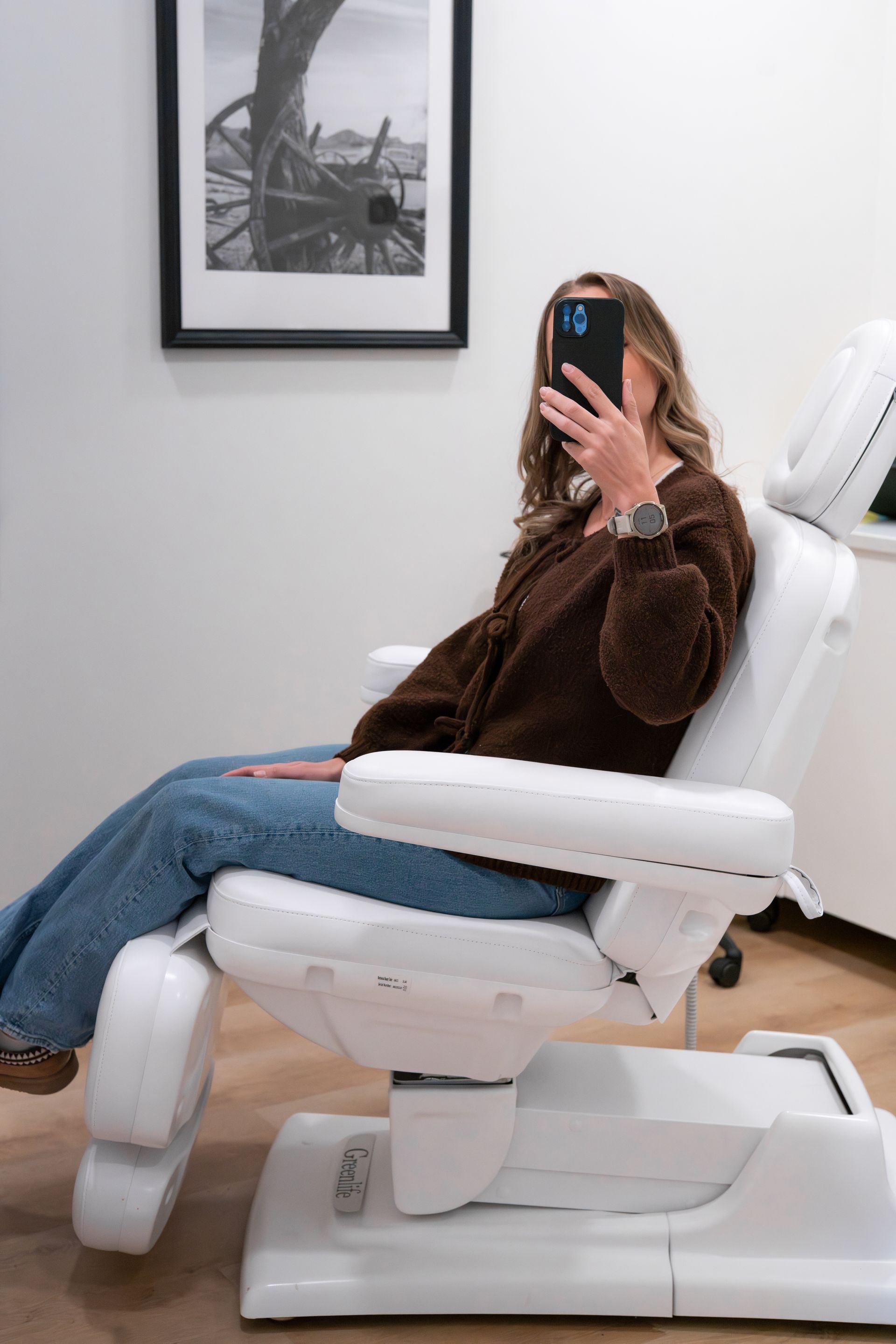 a woman with a towel wrapped around her head is holding slices of cucumber over her eyes .