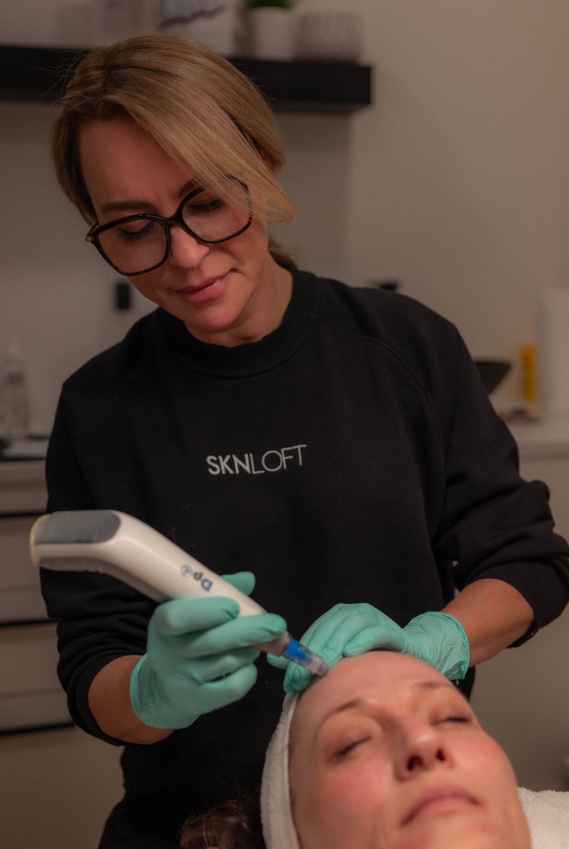 a woman is getting a microneedling treatment