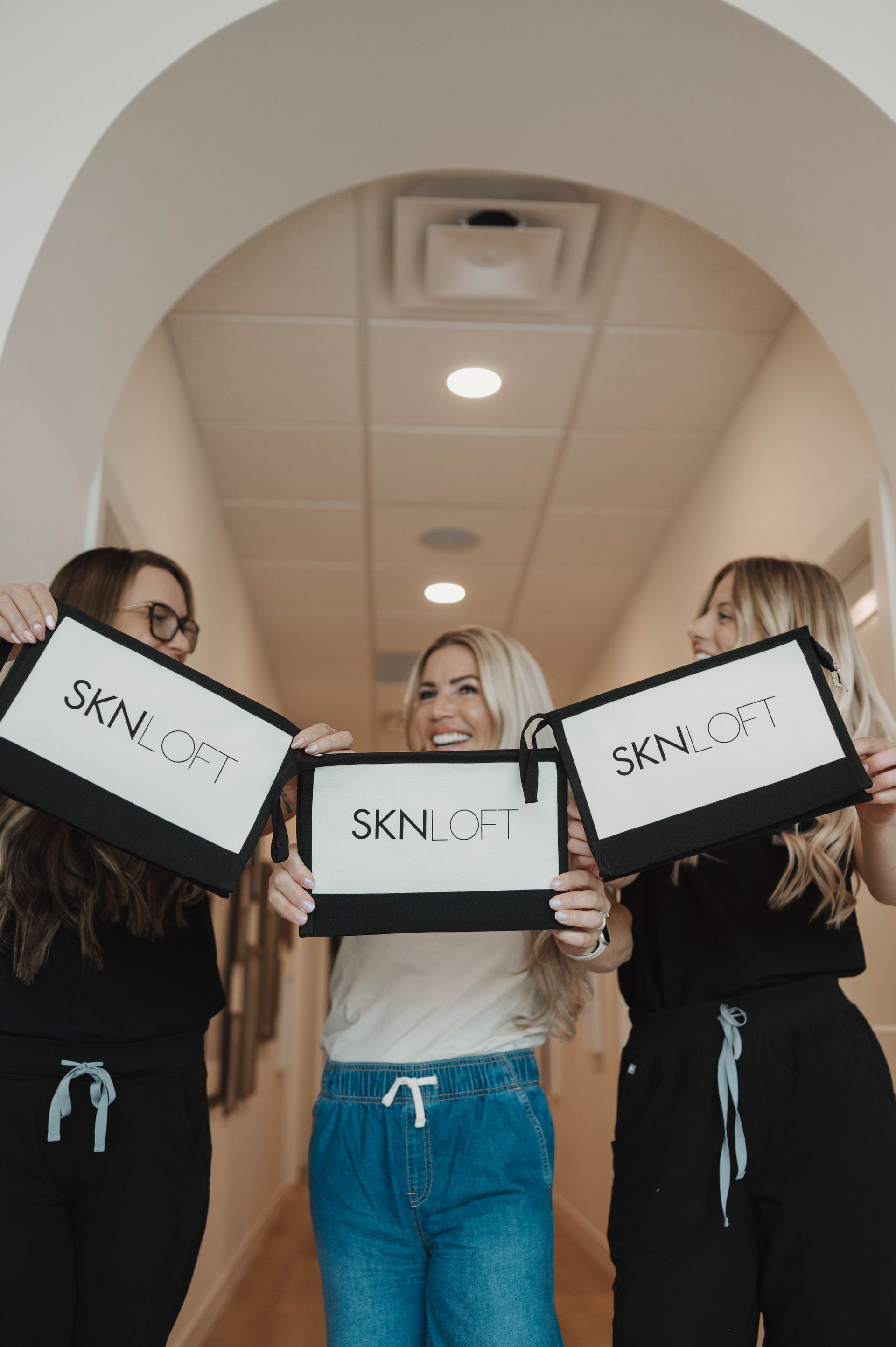Three women holding signs that read