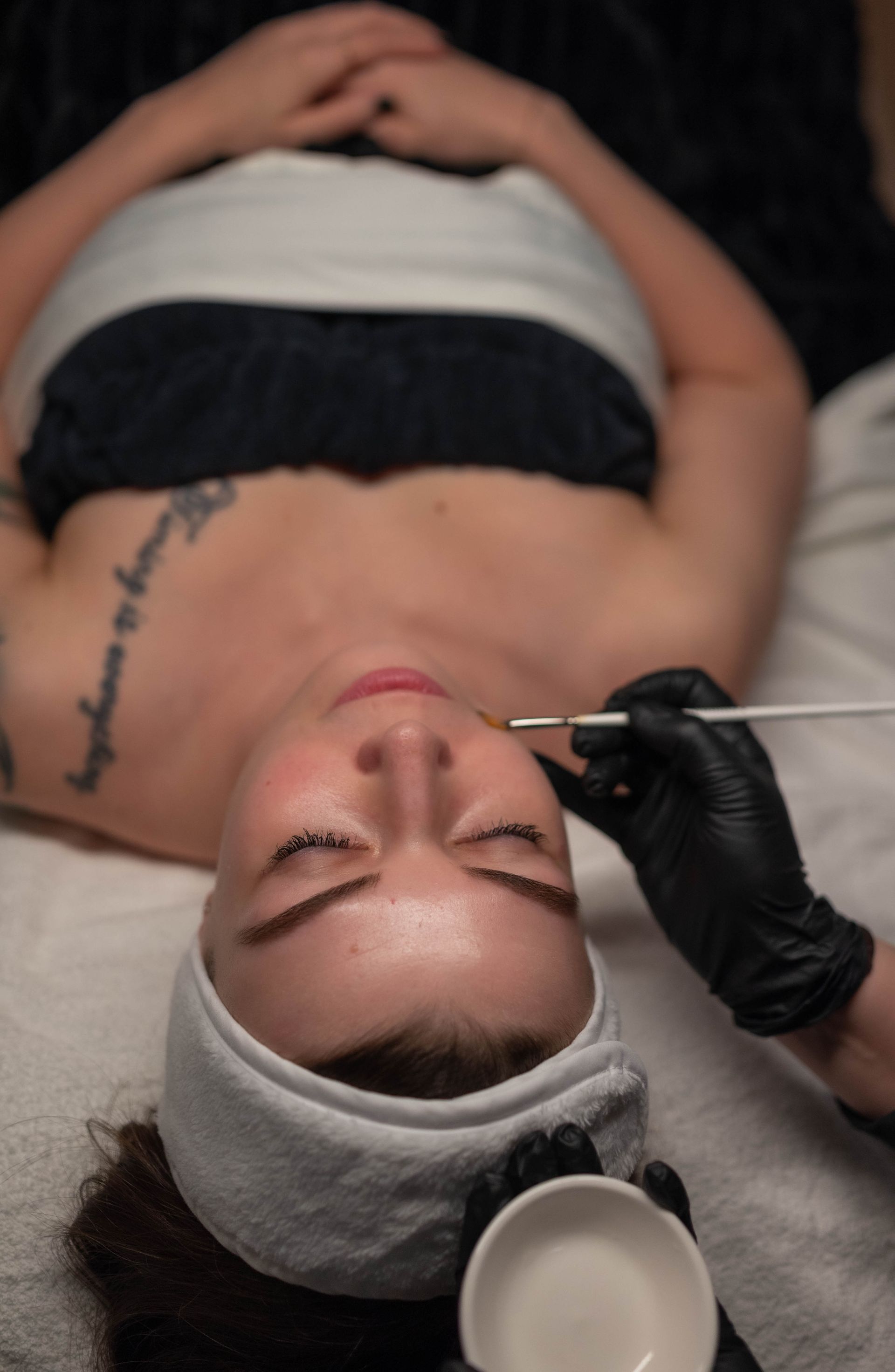 a close up of a woman 's face with her hand on her face .