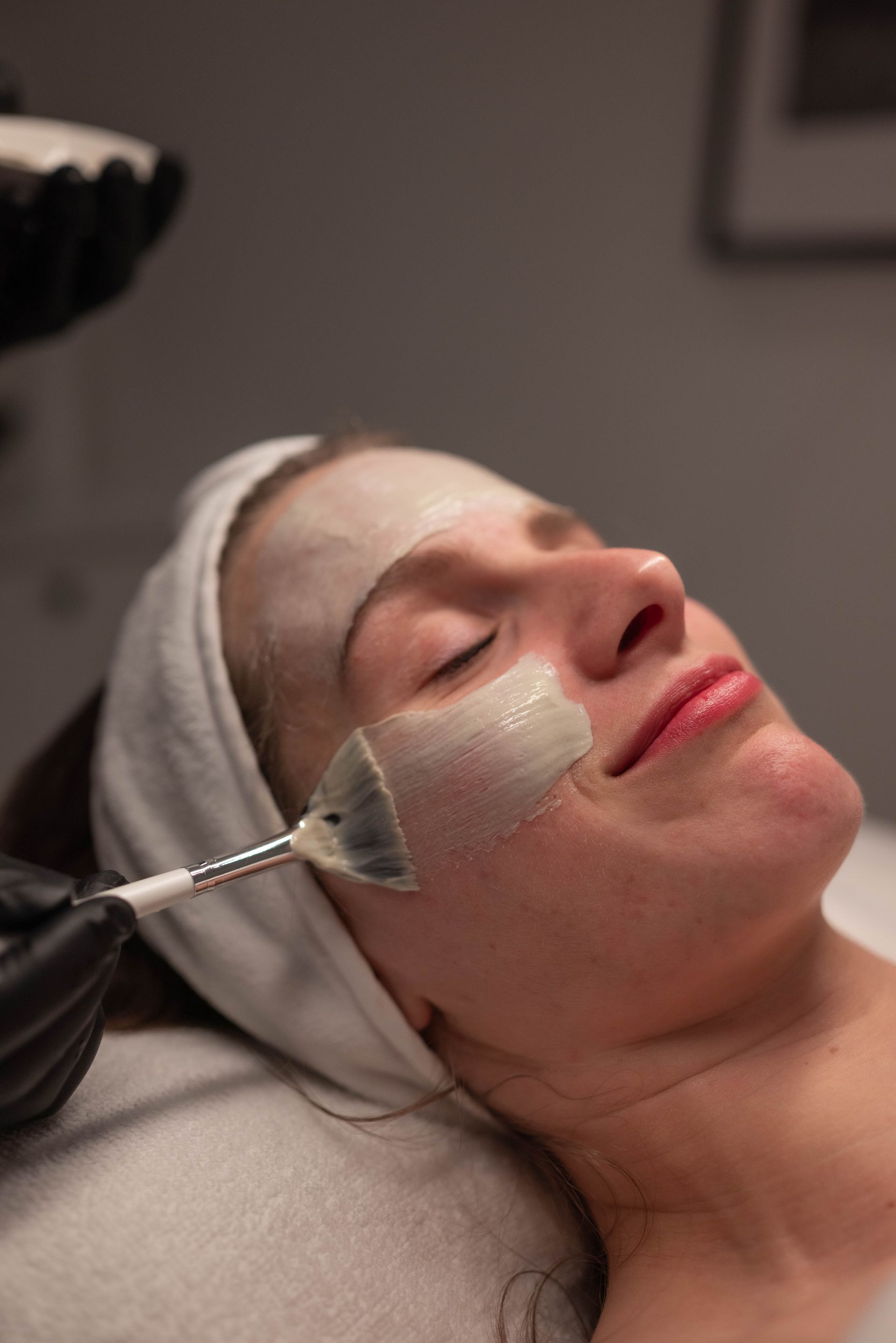 A woman is getting a facial treatment at a spa.