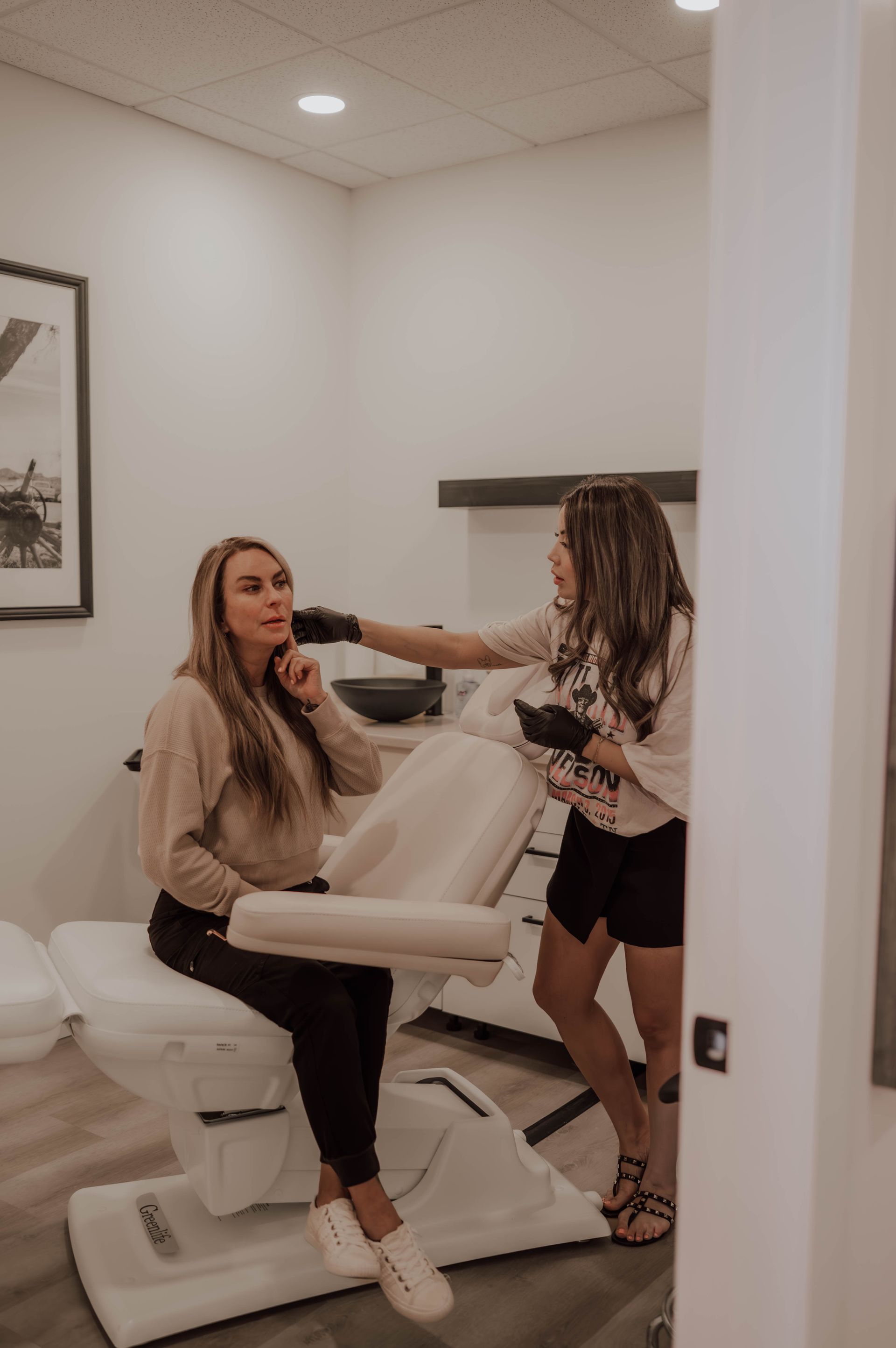 A woman is getting a facial massage at a spa.