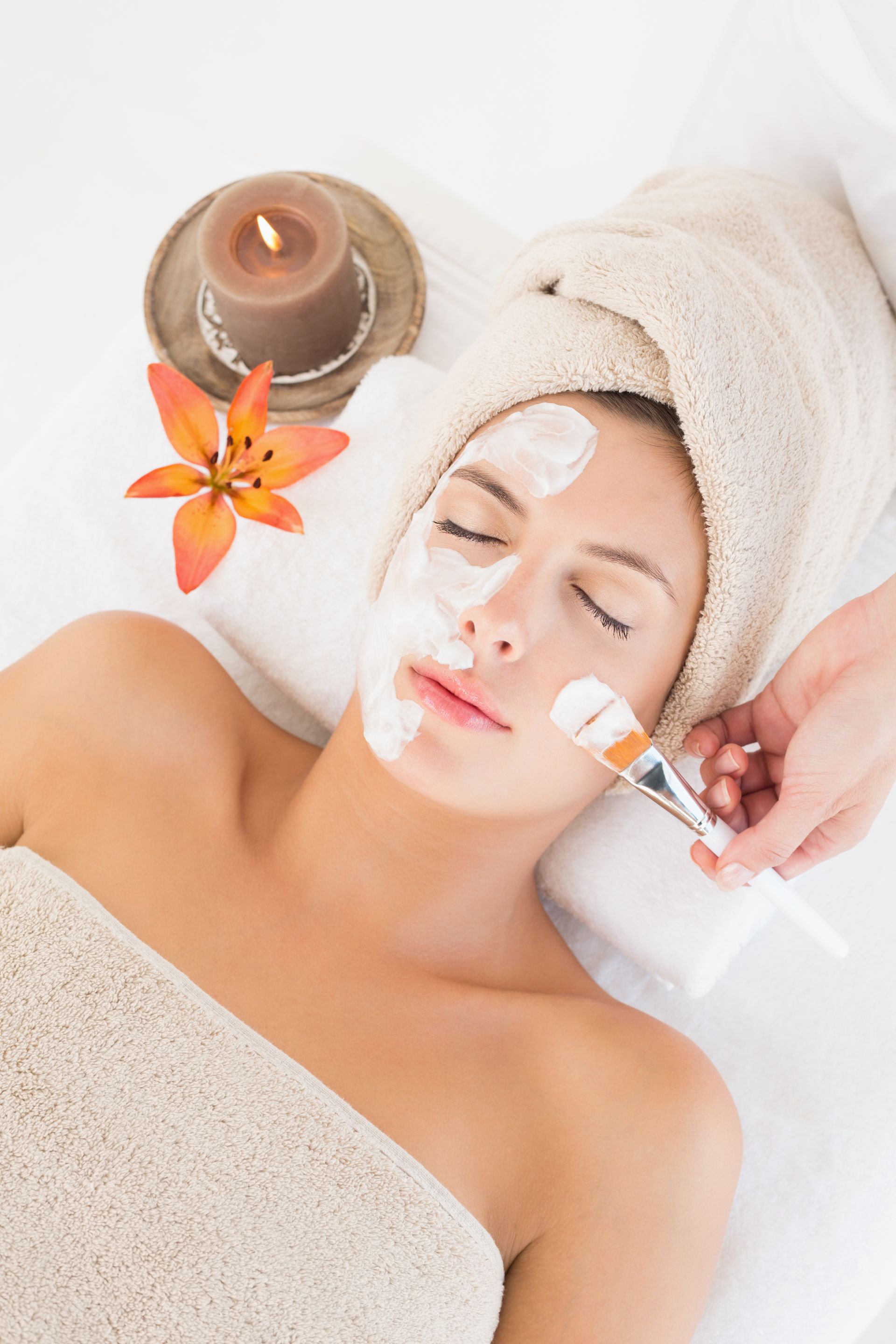 A woman is getting a facial treatment at a spa.