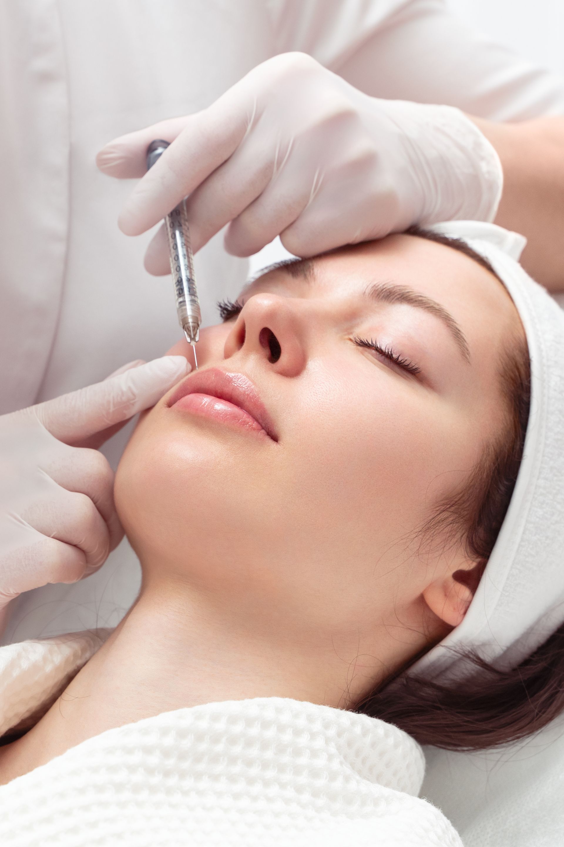 a woman is getting a facial treatment at a beauty salon .