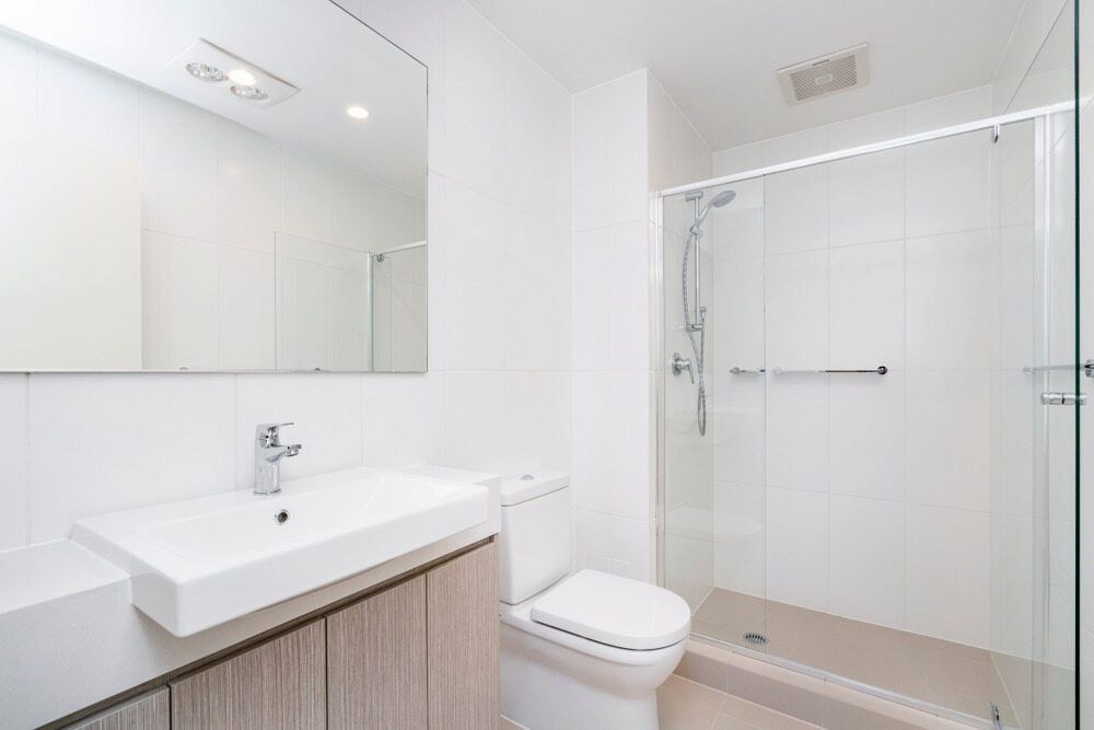 A Bathroom With a Toilet, Sink and Shower — Bulli Glass in Albion Park, NSW