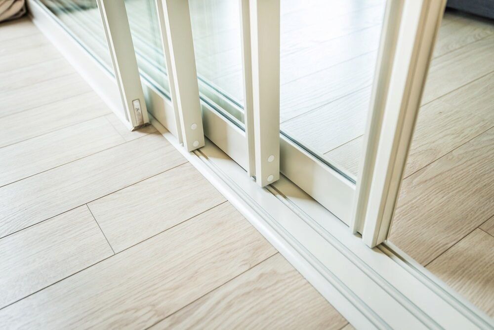 A Sliding Glass Door on a Wooden Floor — Bulli Glass in Wollongong, NSW