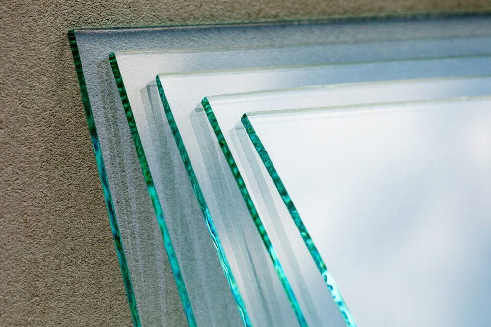 Three Pieces of Glass Are Stacked on Top of Each Other on a Concrete Surface — Bulli Glass in Bulli, NSW