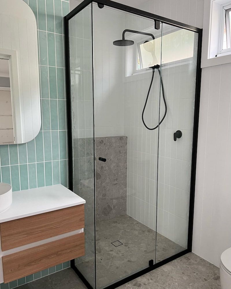 A Bathroom with a Shower, Sink, Toilet and Mirror — Bulli Glass in Wollongong, NSW