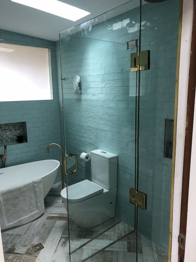 A Bathroom with a Toilet, Bathtub, and Shower Stall — Bulli Glass in Bulli, NSW