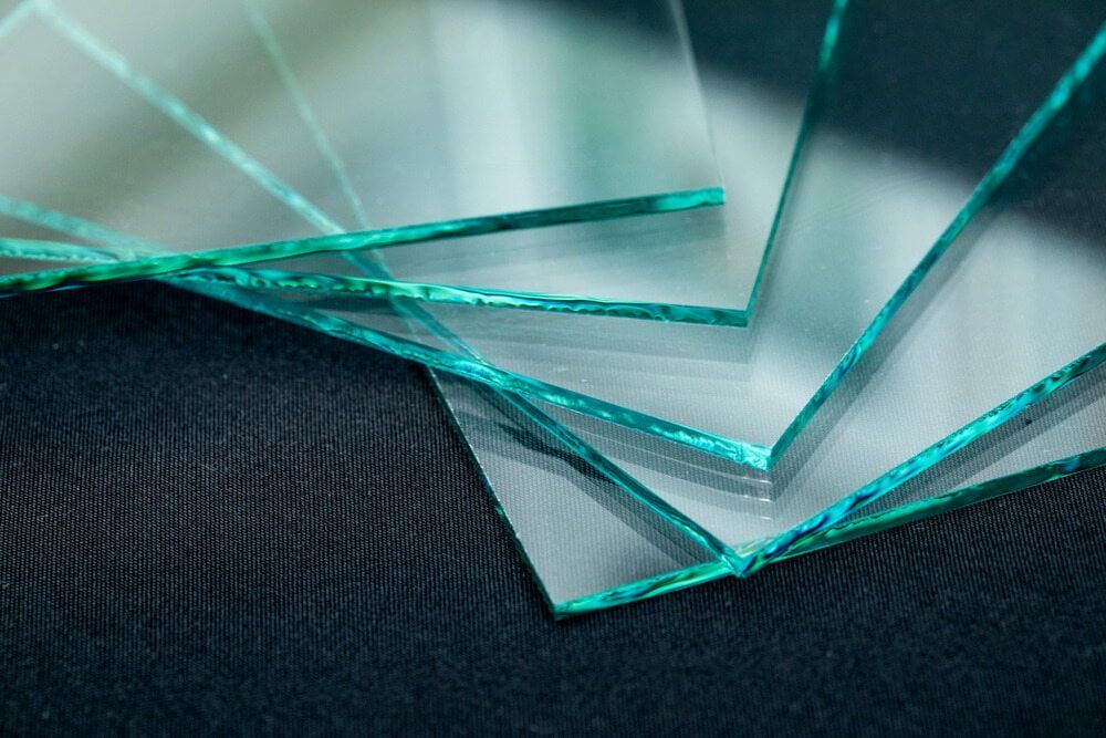A Stack of Clear Glass Pieces on a Black Surface — Bulli Glass in Bulli, NSW