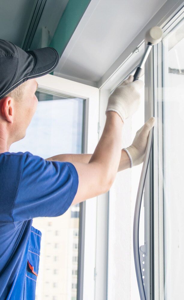 A Man is Installing a Window — Bulli Glass in Bulli, NSW