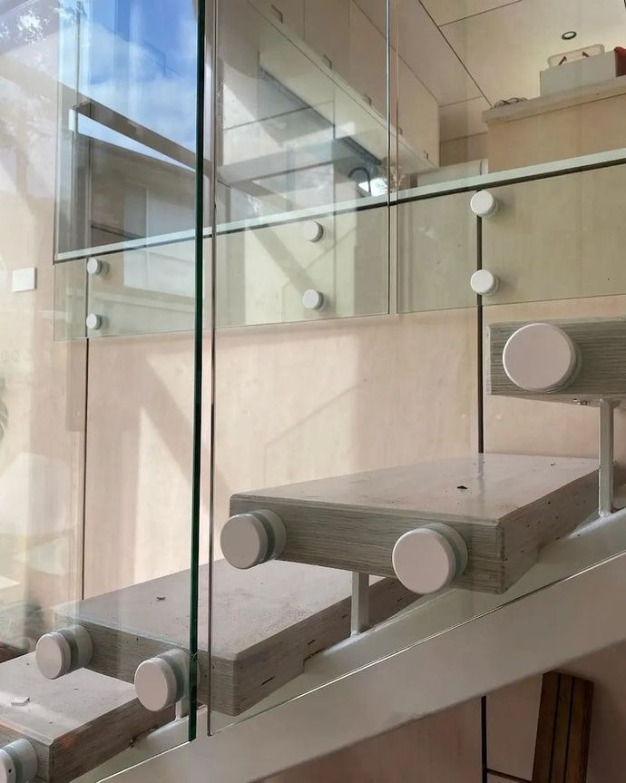 A Staircase with a Glass Railing and Wooden Steps — Bulli Glass in Bulli, NSW