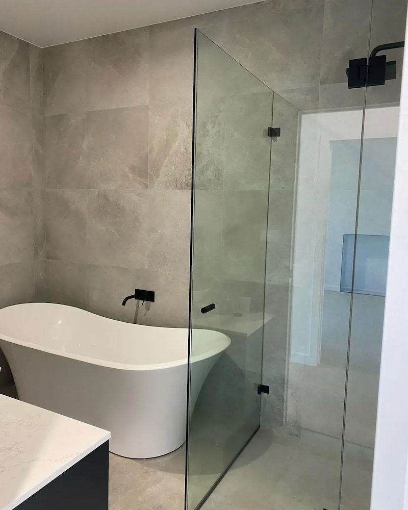 A Bathroom with a Bathtub and a Walk in Shower — Bulli Glass in Albion Park, NSW