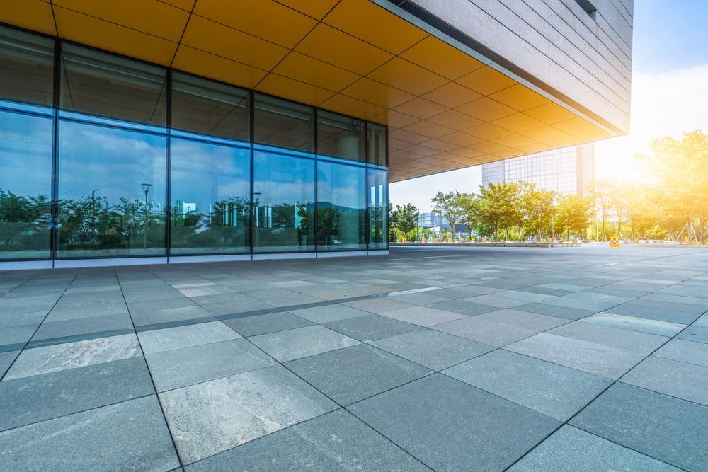 A Large Building with a Lot of Windows and a Tiled Floor in Front of It — Bulli Glass in Kiama, NSW