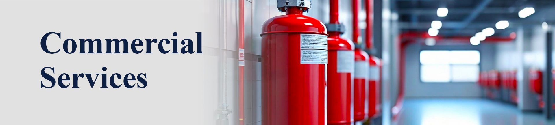 Red fire extinguishers in a commercial hallway with the words