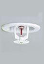 White fire sprinkler head mounted on a ceiling.