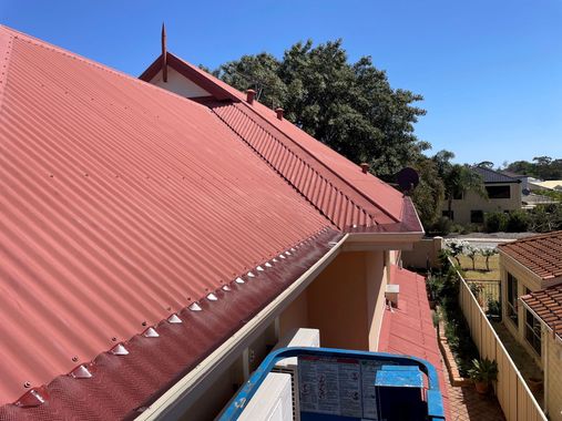 a red roof with a gutter on the side of it