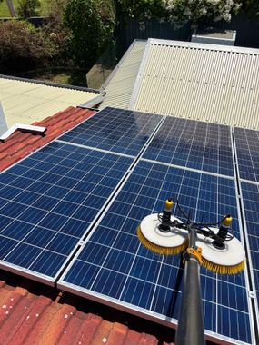 a row of solar panels on the roof of a house .