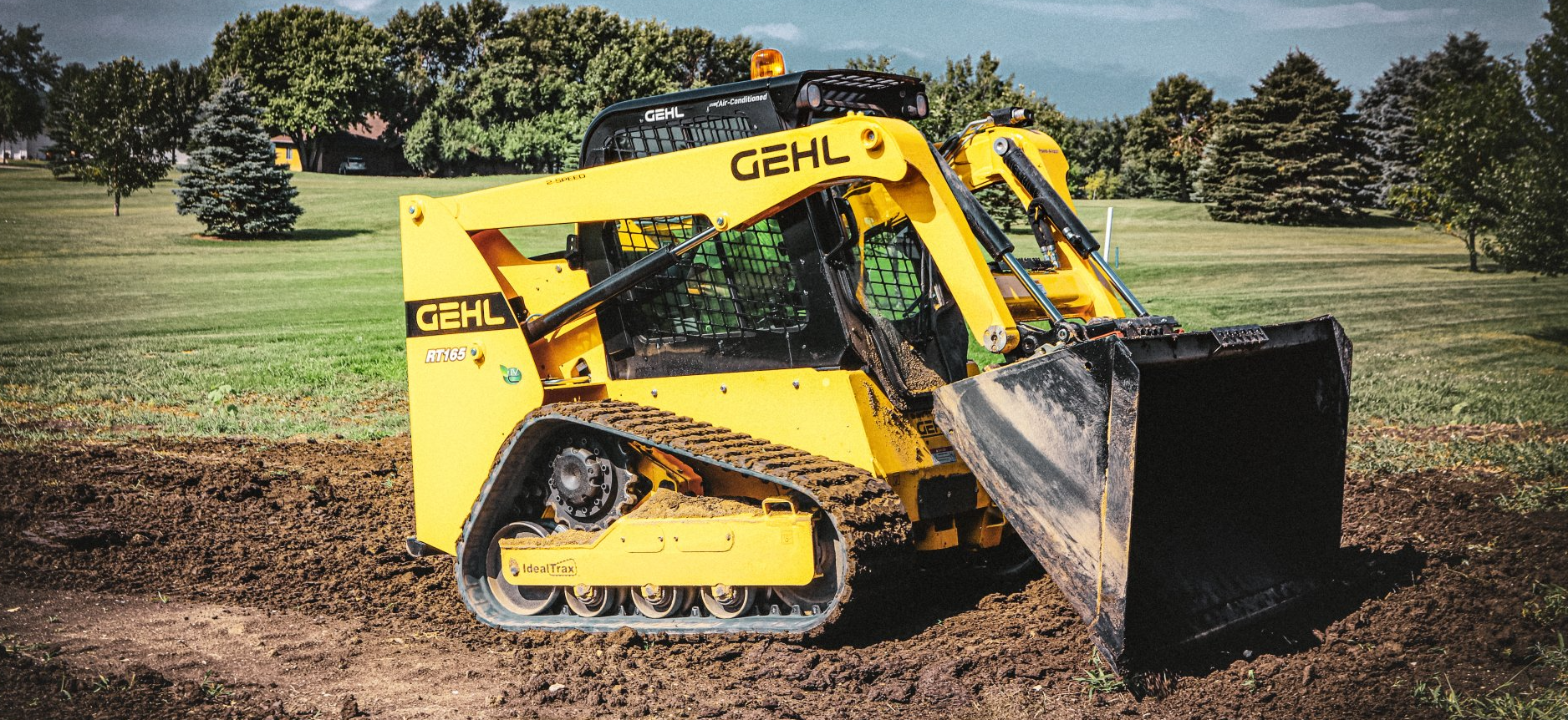 gehl rt165 track loader photo digging in dirt