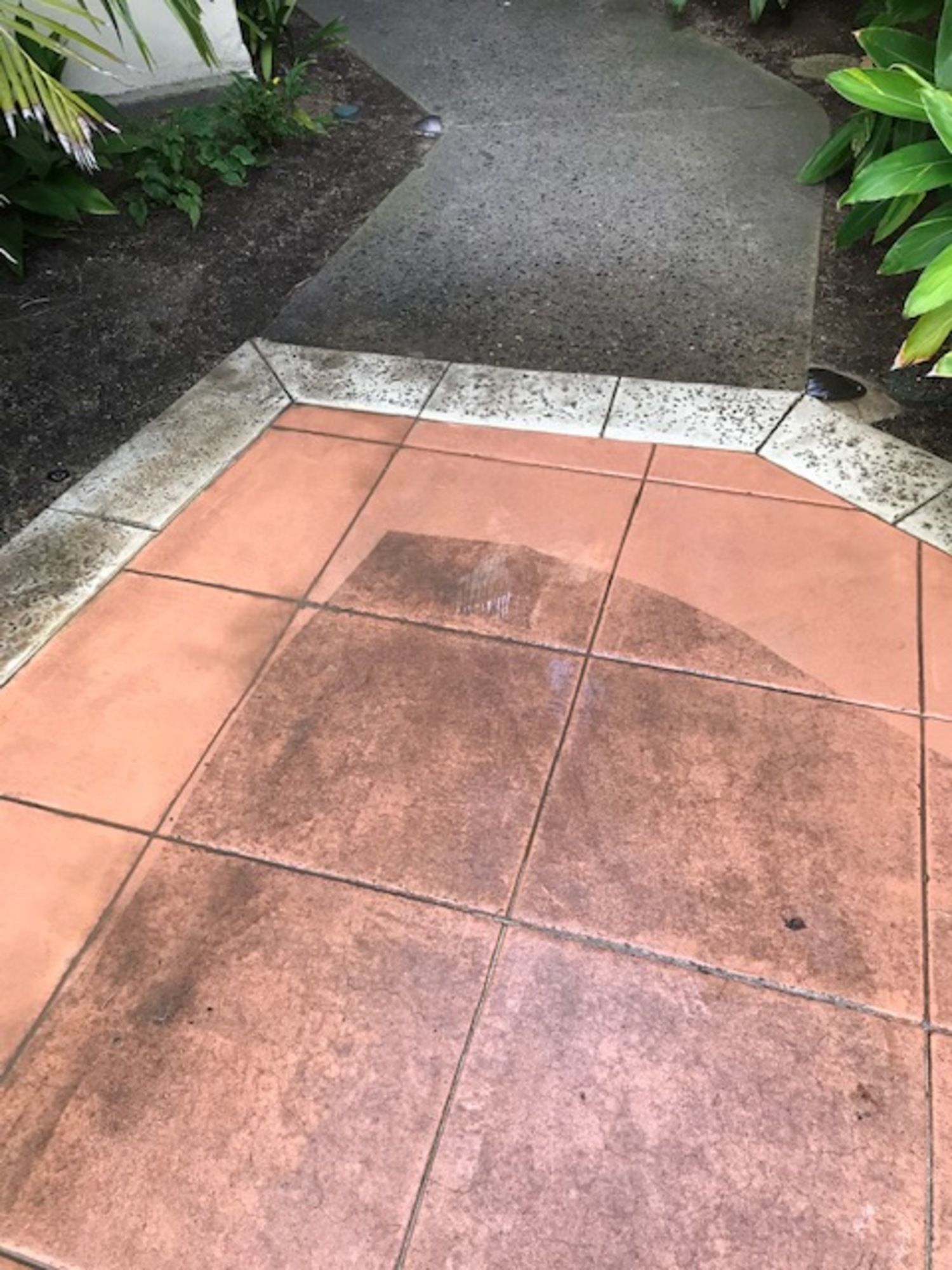 A dirty tile floor next to a walkway.