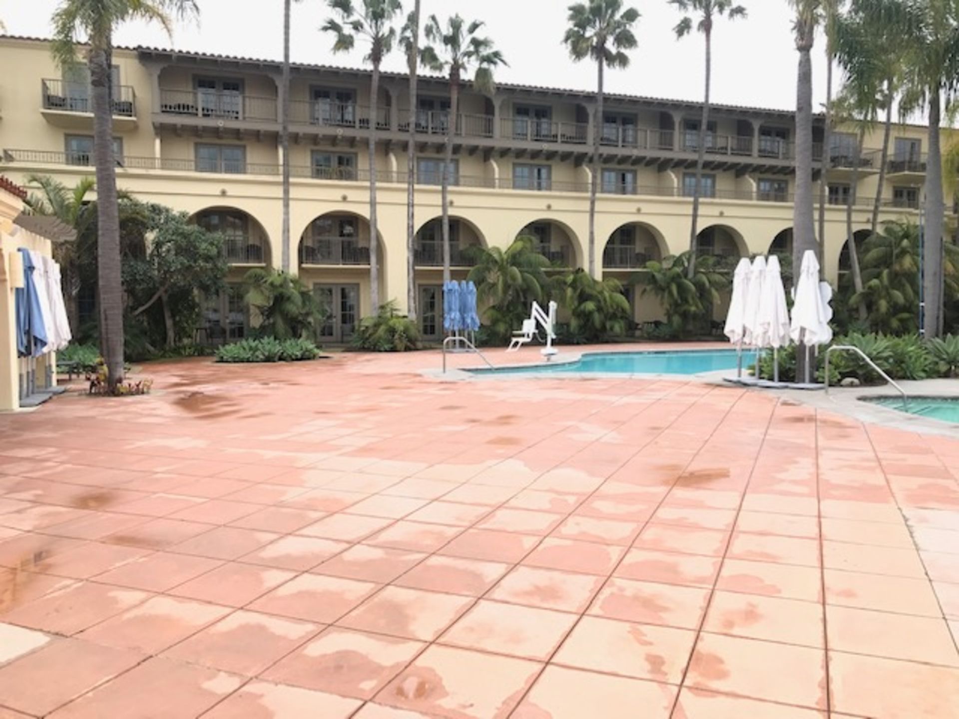 A large building with a swimming pool in front of it