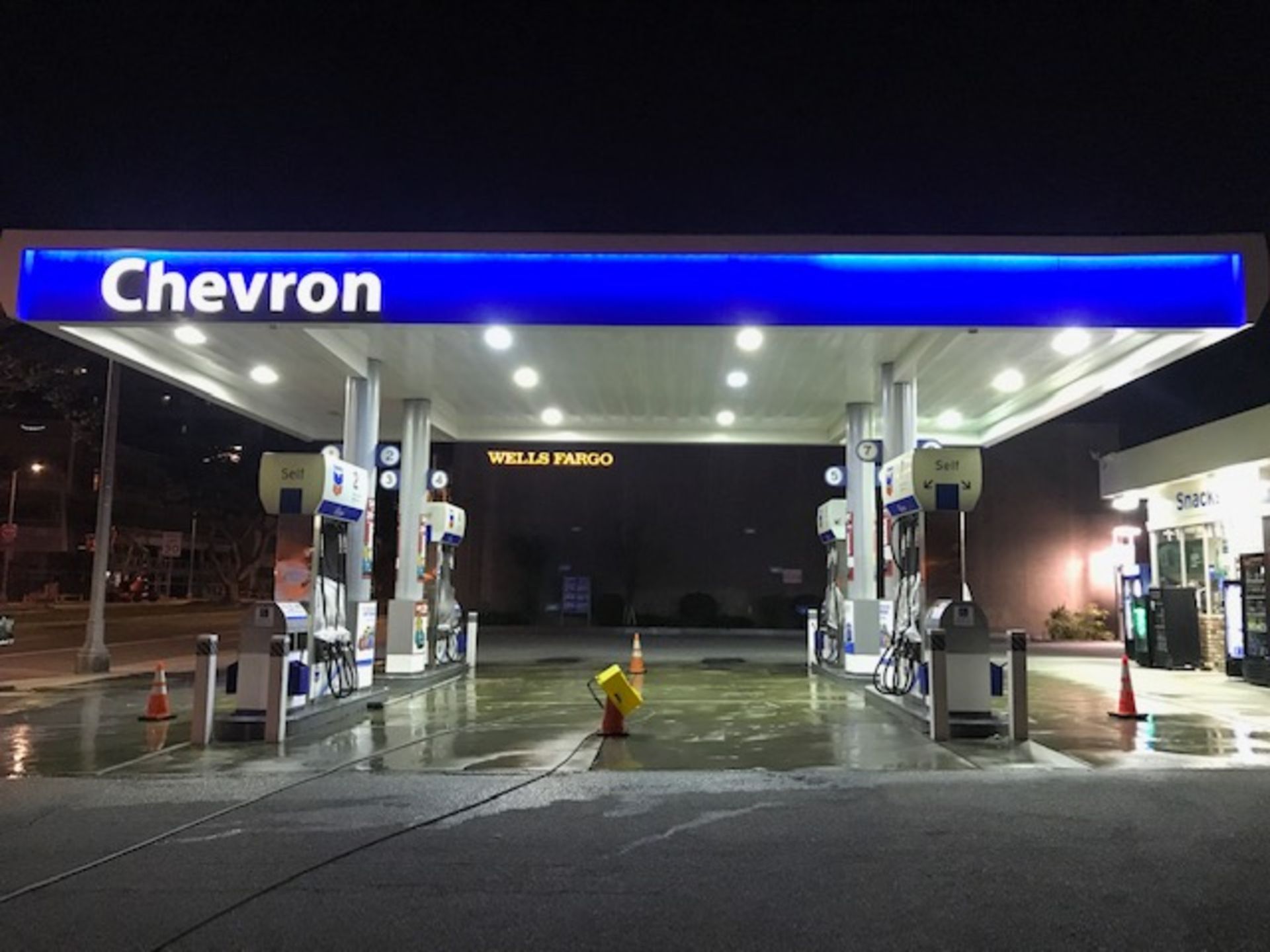 A chevron gas station is lit up at night