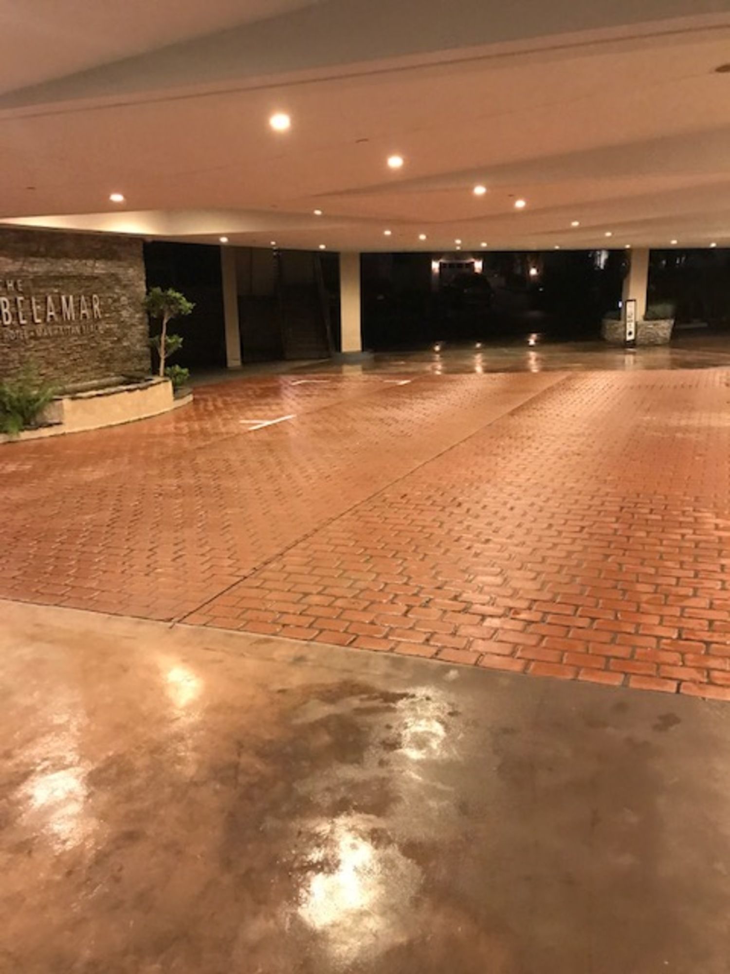 A large empty parking lot with a brick floor.