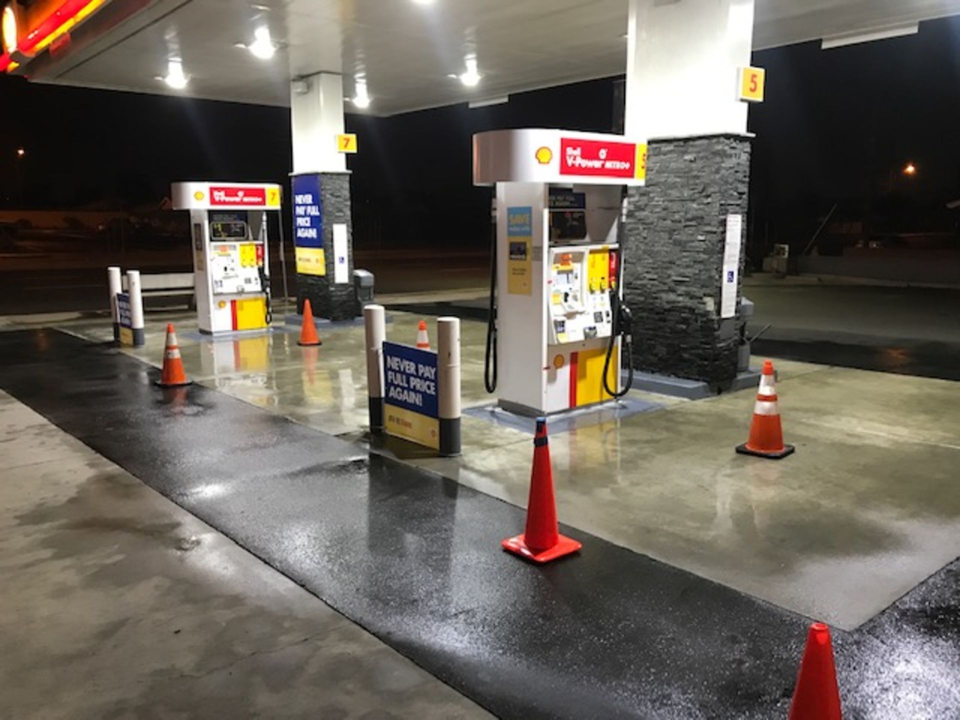 A gas station with a lot of cones in front of it