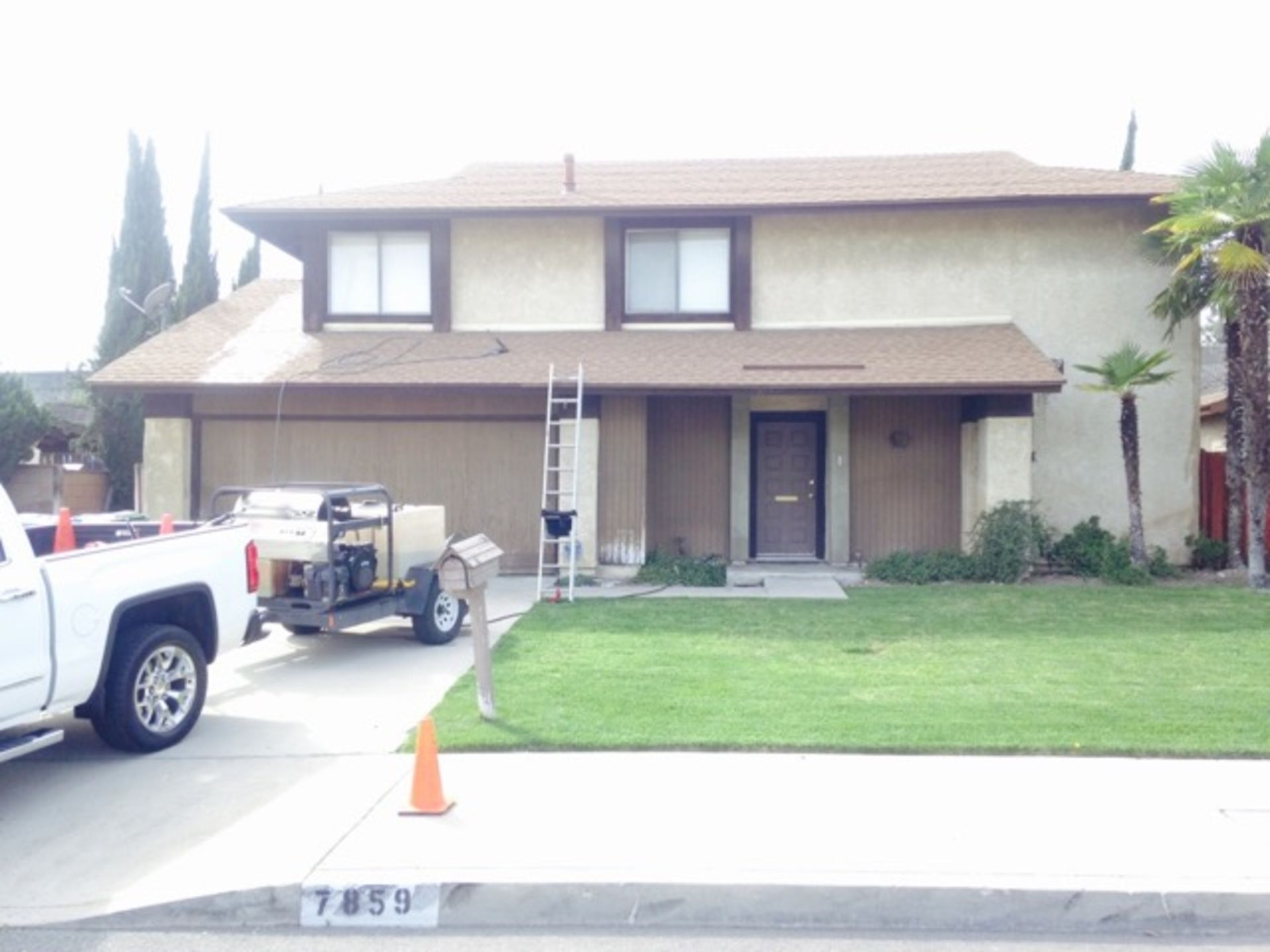 A white truck is parked in front of a house