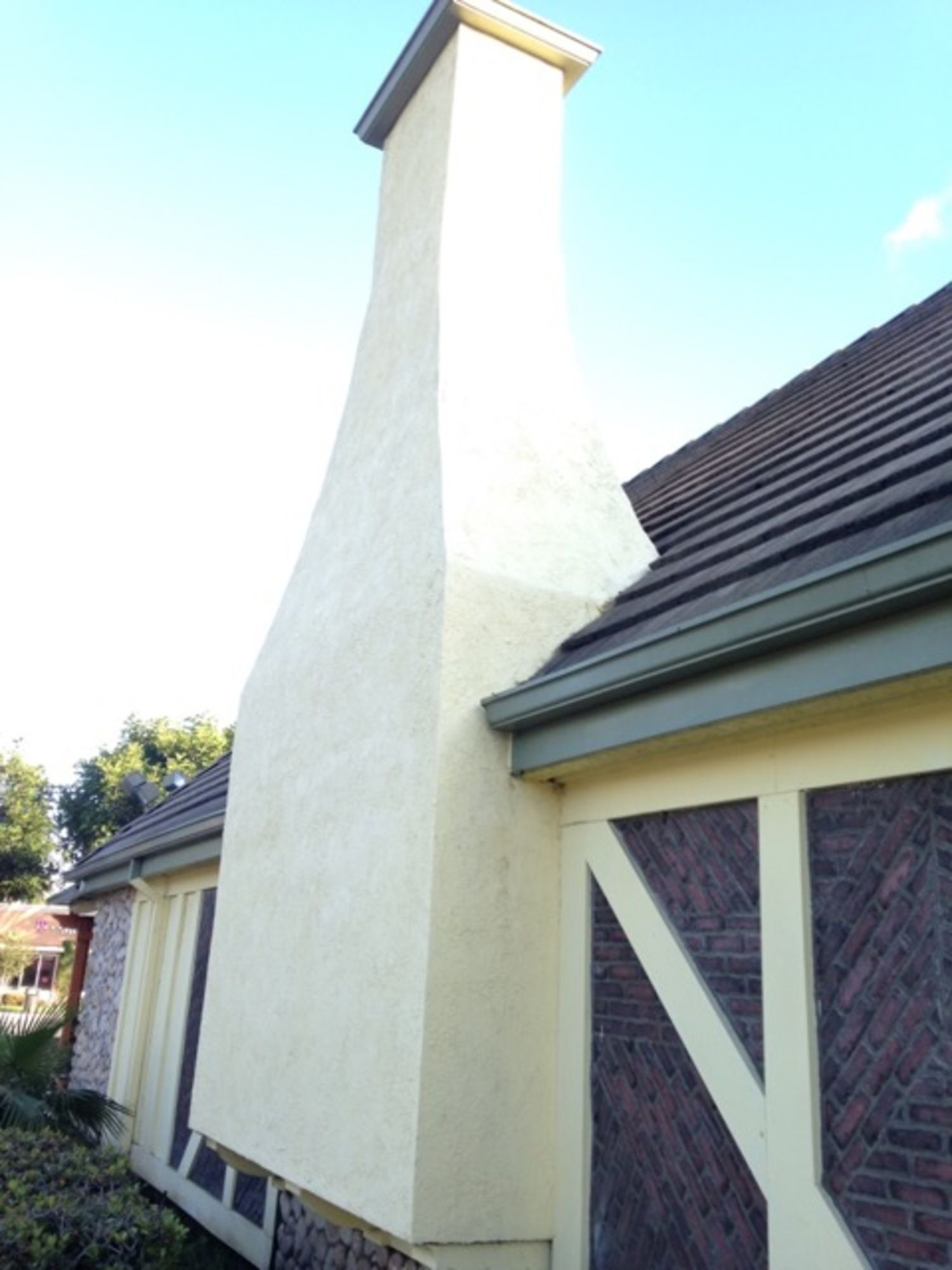 A large chimney on the side of a house