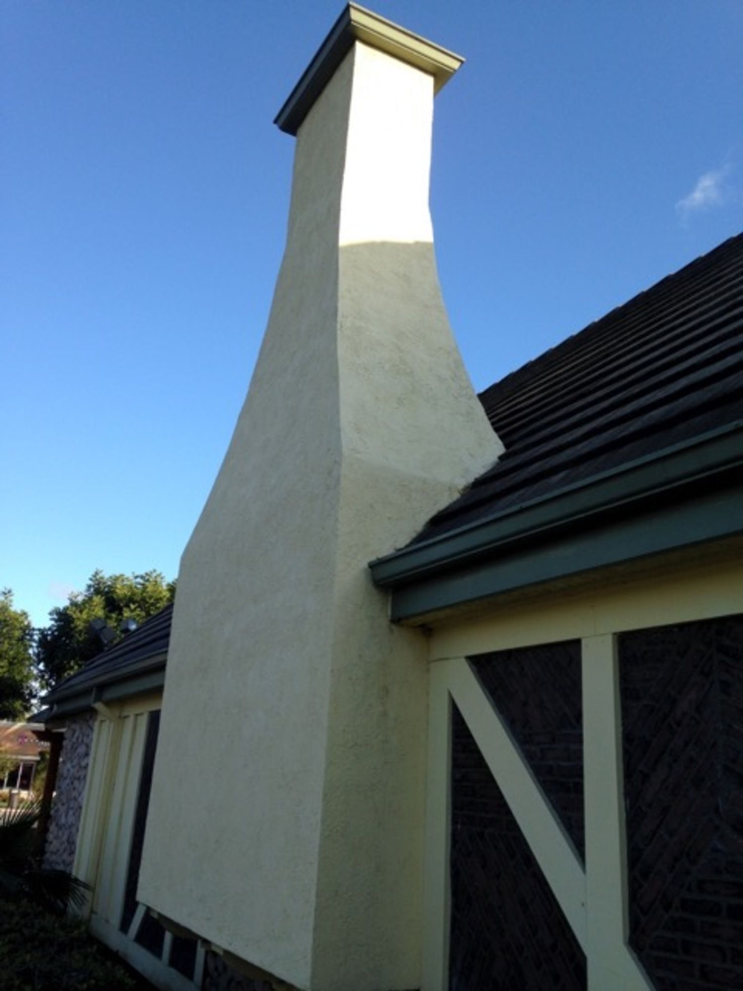 A large chimney on the side of a house