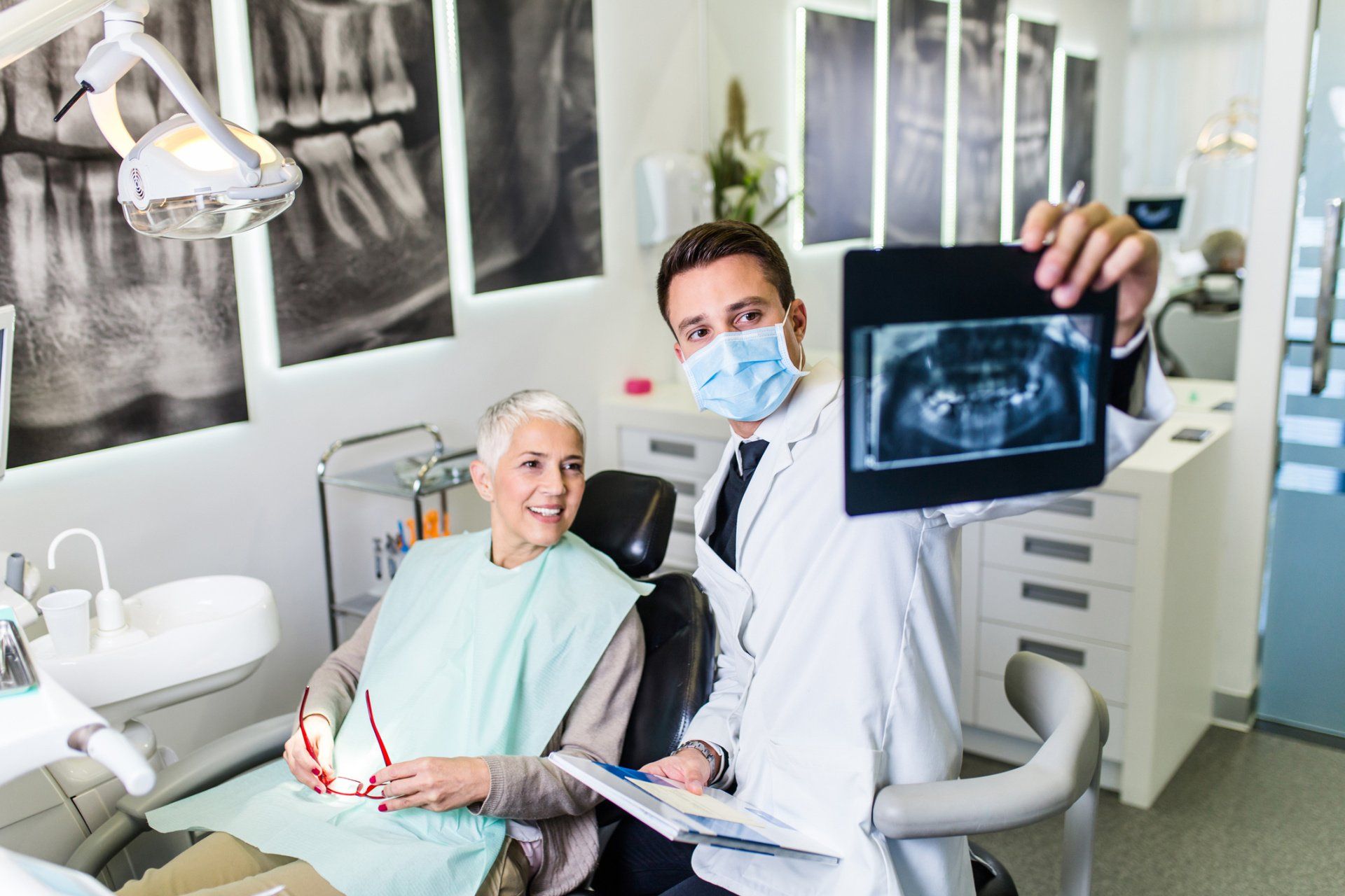 Teeth Filling — Dentist Showing Patient's X-ray in Tupelo, MS