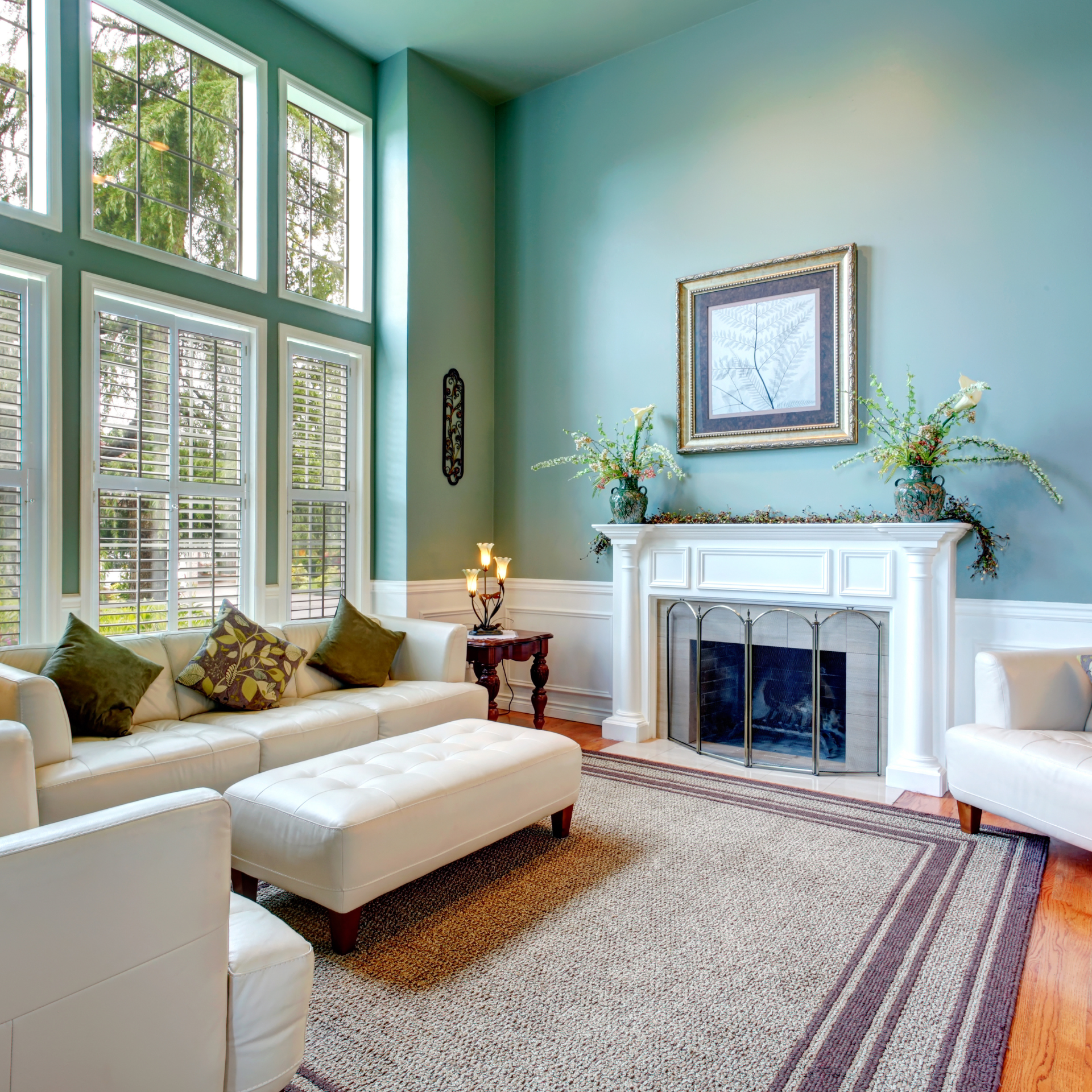 A living room with blue walls and a fireplace
