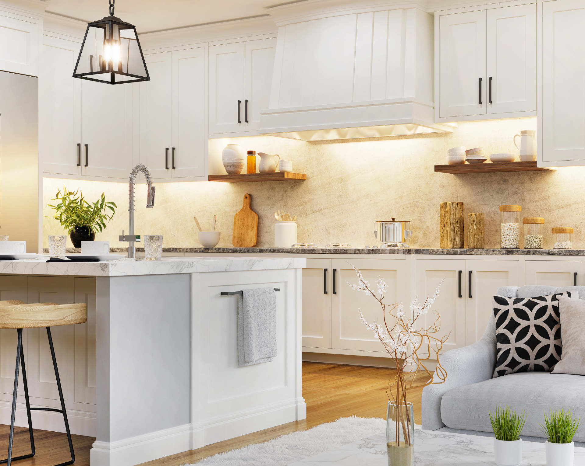 A kitchen with white cabinets and a living room with a couch.