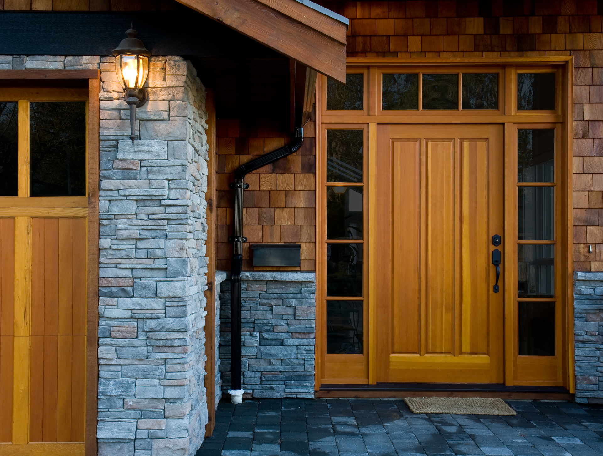 A house with a wooden door and a stone wall