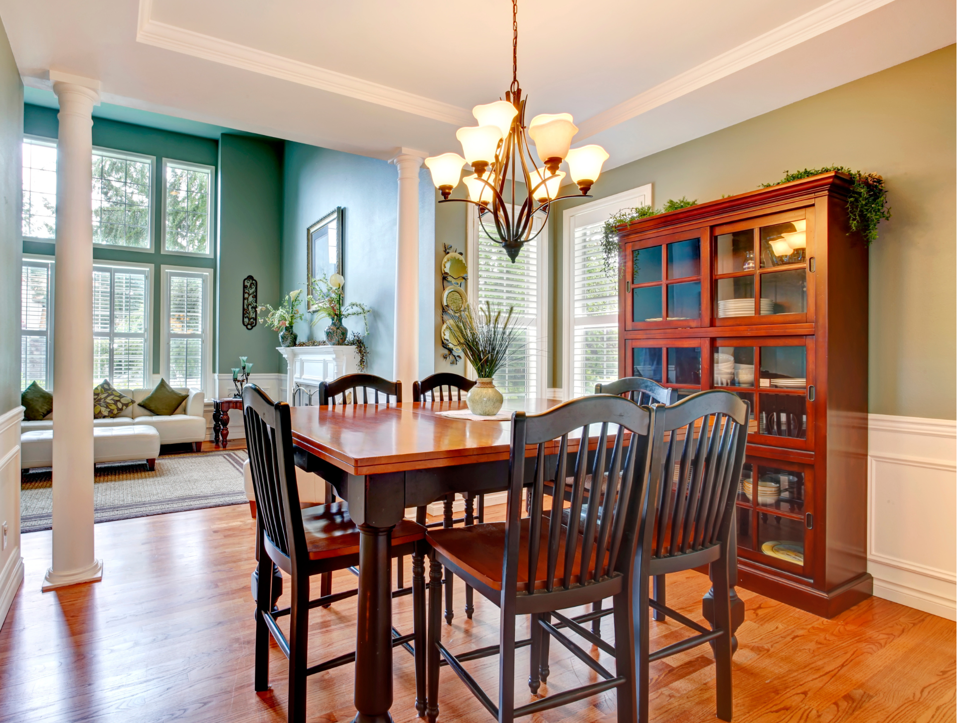 A dining room with a table and chairs and a chandelier.